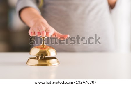 Close-up Of Woman\'s Hand Ringing Service Bell