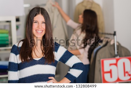 Happy Young Woman Standing In Shopping Mall, Indoors