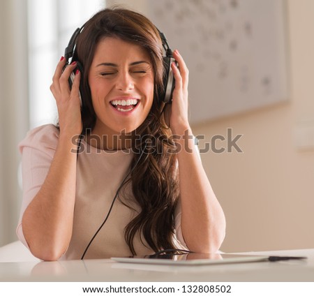 Happy Young Woman Listening To Music On Headphones