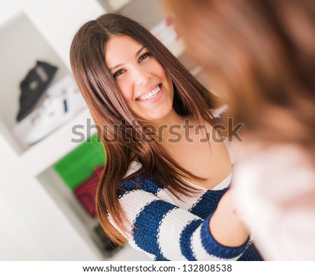 Portrait Of Happy Woman Shaking Hand, Indoors