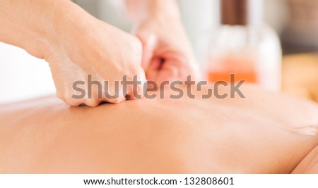 Attractive Woman Having A Massage With Massage Oil In A Spa
