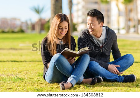 Young Happy Friends Studying In Park