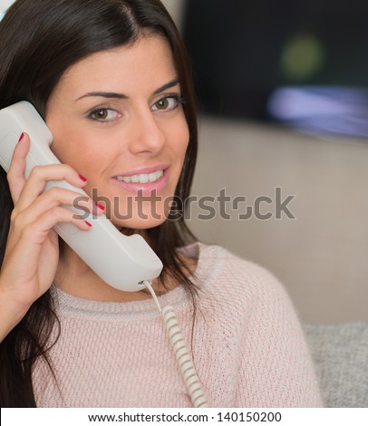 Woman Talking On Land line Telephone, Indoors