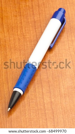 office pen on a wooden surface, closeup