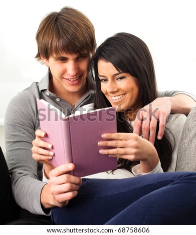 couple reading a book on white background