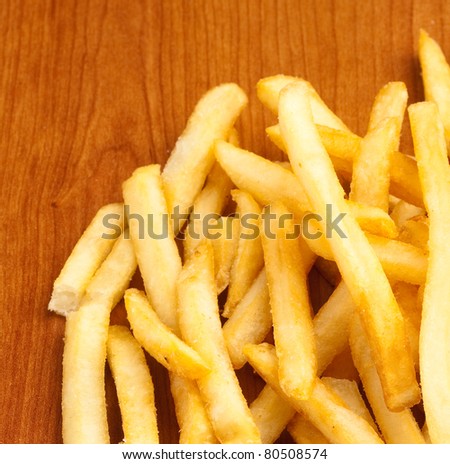 fried potato chips on a wooden surface