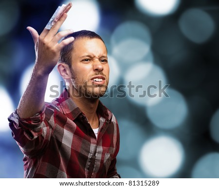 young lucky businessman with euro notes on a lights background