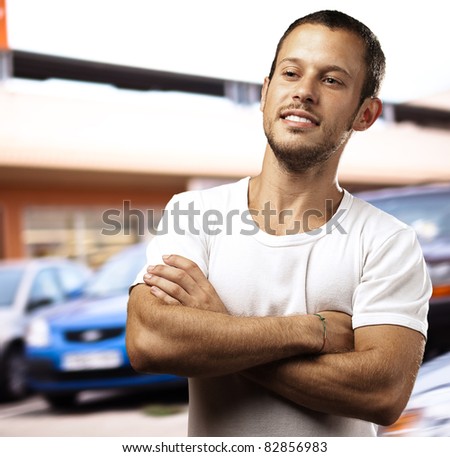 young man with crossed arms in the street