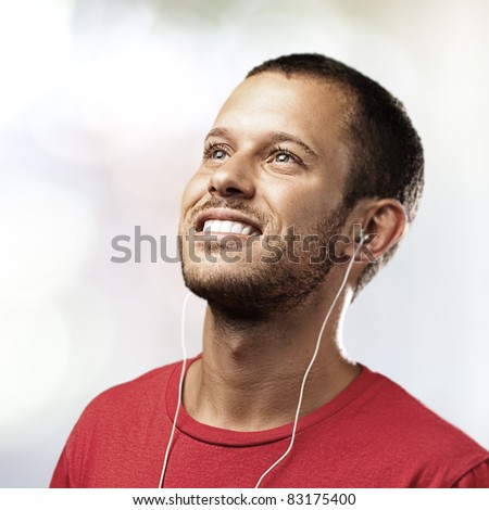 young man listen to music on a lights background