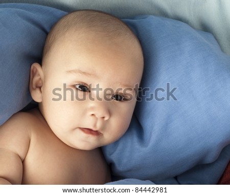 little baby resting under a blue blanket