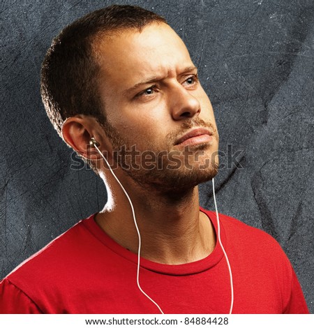 young man listen to music against a grunge background