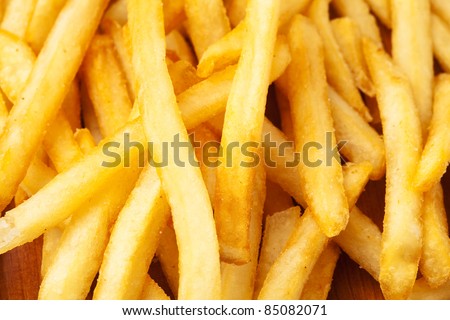 fried potato chips on a wooden surface