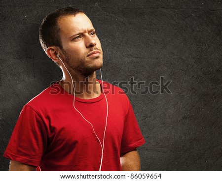 young man listen to music against a grunge background