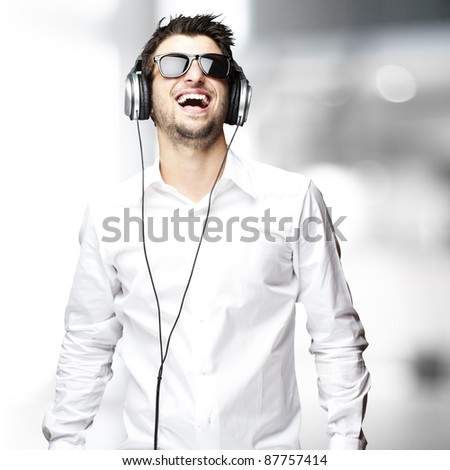 portrait of a handsome young man listening music indoor
