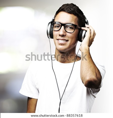 portrait of a handsome young man listening to music indoor