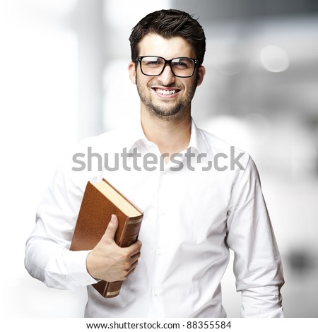 portrait of young student holding book indoor