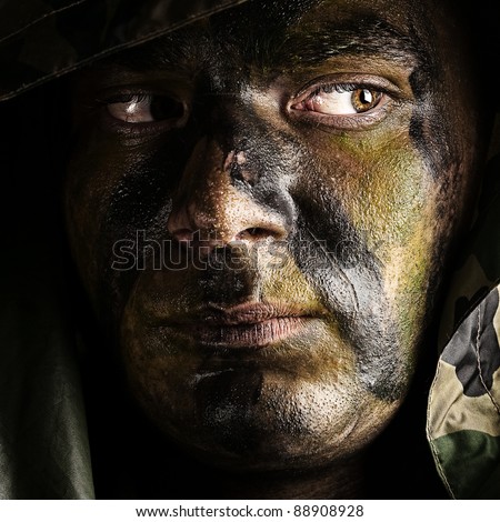 portrait of young soldier face with hood