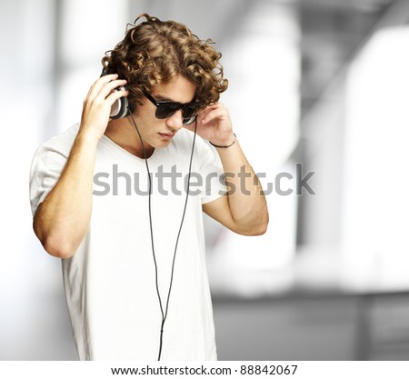portrait of a handsome young man listening music indoor