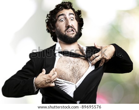 business man with courage and superman concept tearing off his shirt against a abstract background