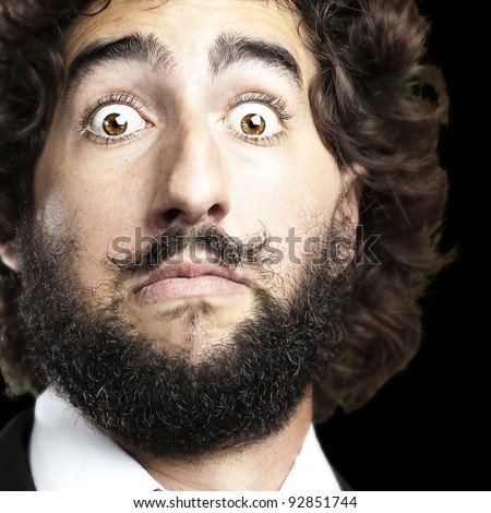 portrait of young man face afraid against a black background