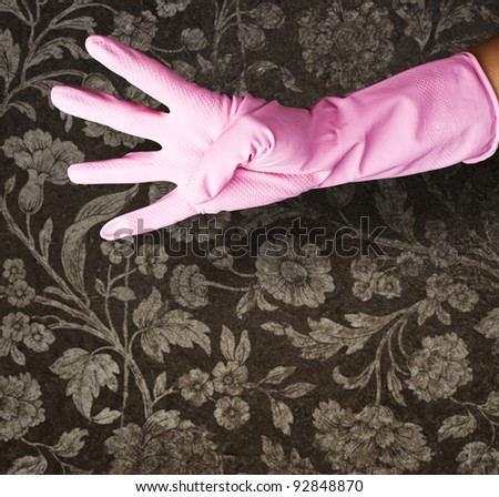 pink gloves of maid gesturing number four against a vintage wall