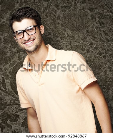 portrait of a handsome happy man against a vintage wall
