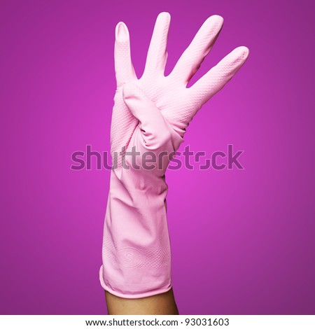 pink gloves of maid gesturing number four against a pink background