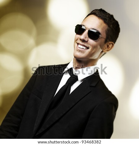 portrait of business man smiling against a golden lights background