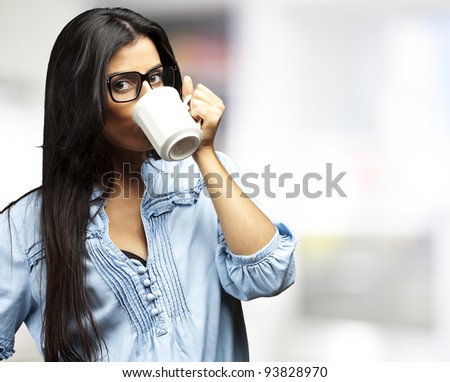 portrait of a young woman drinking coffee indoor