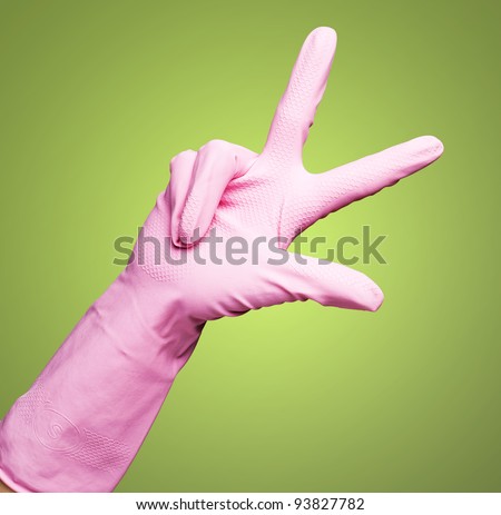 pink gloves of maid gesturing number three against a green background