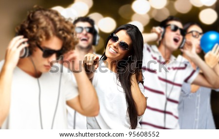 portrait of young people having a party against a golden lights