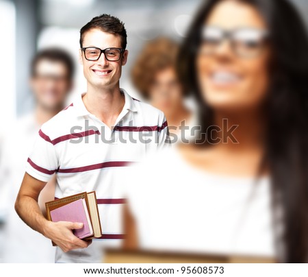 portrait of young students holding books indoor