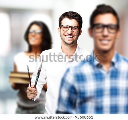 portrait of young art students holding books indoor
