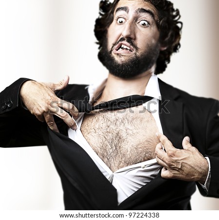 business man with courage and superman concept tearing off his shirt against an abstract background
