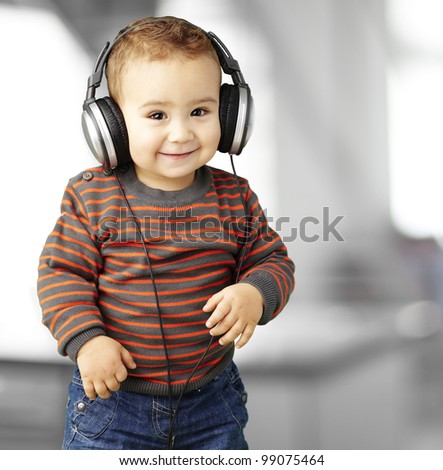 portrait of a handsome kid listening to music and smiling indoor