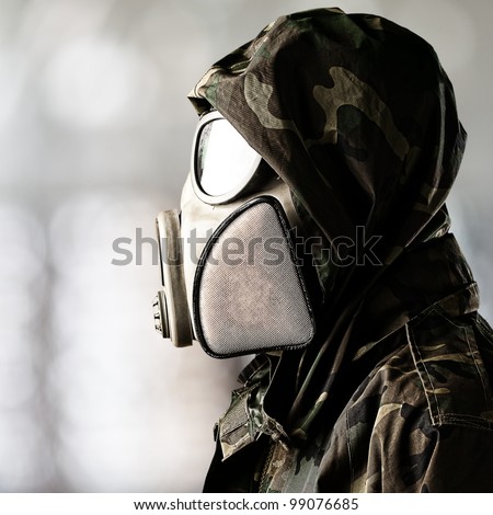 portrait of soldier wearing gas mask over abstract background