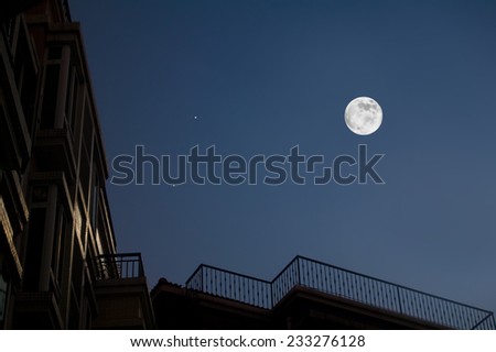 Moon and house roof in night piec.