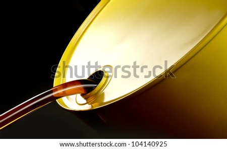 Close up shot of oil flowing out of yellow barrel