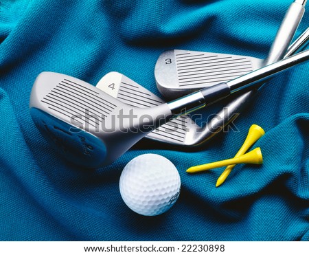 Golf clubs and ball on golf shirt background