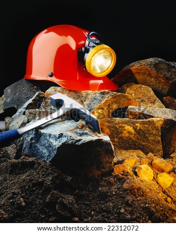 Miner\'s helmet with pick axe and rocks