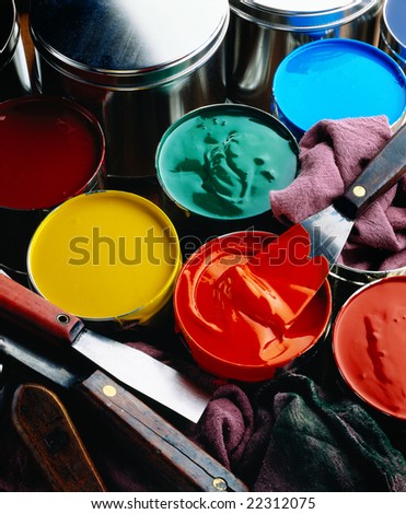 Cans of printing inks with ink knives and wipers