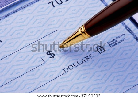 close up of a pen about to write on blank check