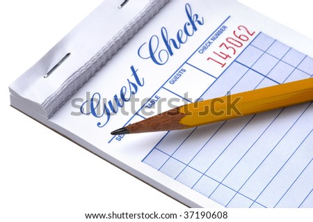 Pad of blank guest checks with pencil shot on white background