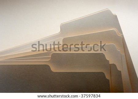 Close up of several dramatically shot manila folders