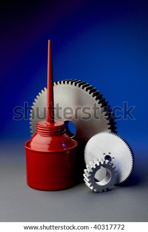 Red oil can with 3 steel gears shot on blue background