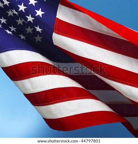 waving american flag background. stock photo : American flag waving in breeze with blue sky ackground