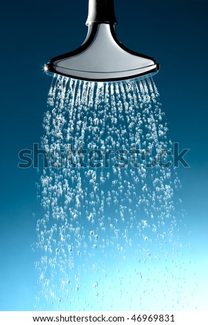 Chrome sprinkler head with water coming out at moderate pressure