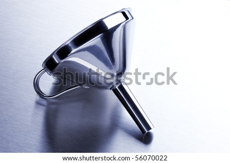 Shiny aluminum funnel shot on stainless steel surface with space for copy