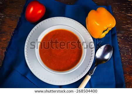 Orange fitness soup in a cup on the blue fabric