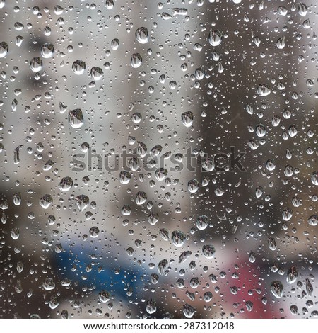 Drops on the glass on the background town houses